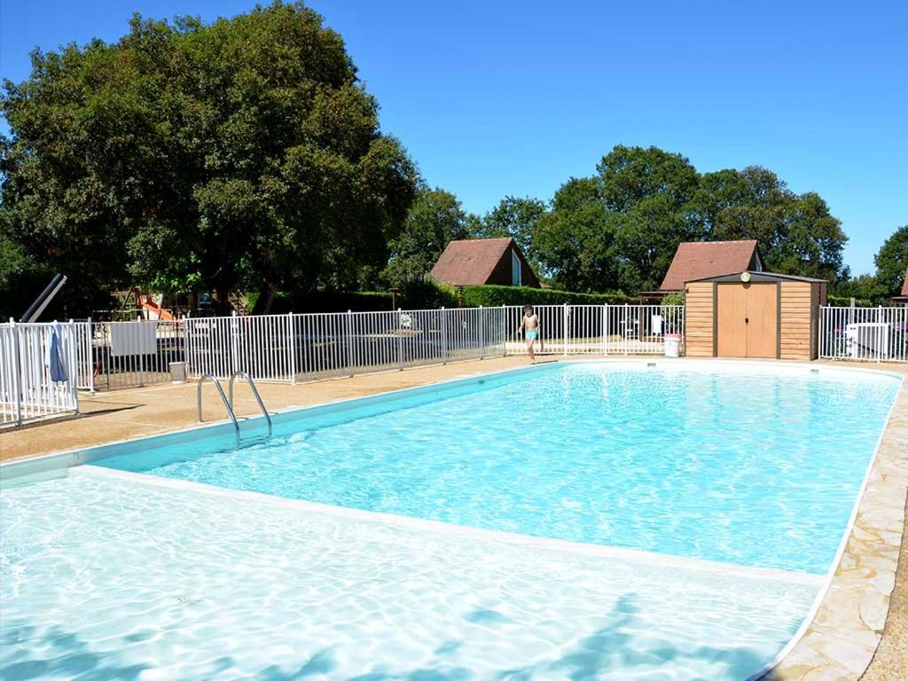une grande piscine avec de l'eau bleue dans l'établissement Camping Le Roc, à Rocamadour