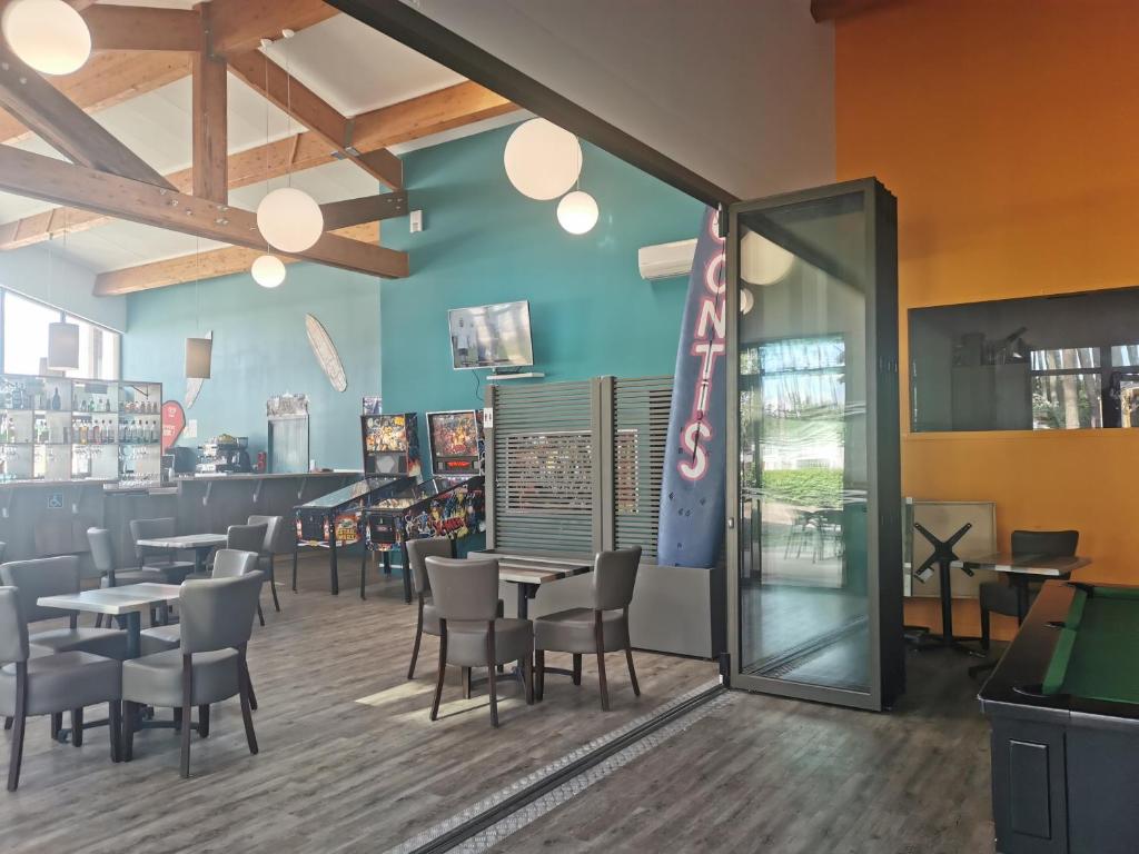 une salle à manger avec des tables et des chaises dans un restaurant dans l'établissement Le Soleil Mobil-home, à Saint-Julien-en-Born