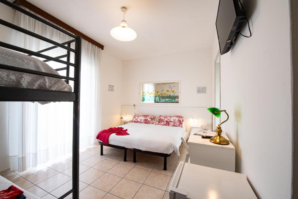 une chambre avec un lit et un lit superposé dans l'établissement Le Petit Hotel, à Lido di Jesolo