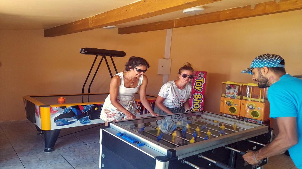Un groupe de gens autour d'un jeu vidéo dans l'établissement Camping Agay, à Agay