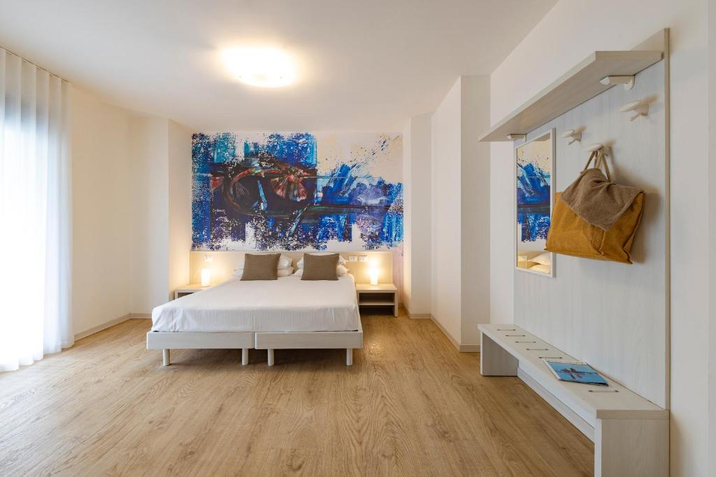 une chambre avec un lit et un tableau au mur dans l'établissement Art Hotel Principe, à Lignano Sabbiadoro