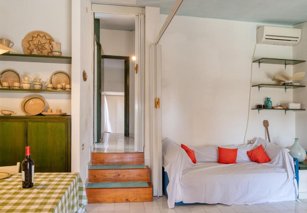 - un salon avec un canapé blanc et des oreillers rouges dans l'établissement Villino Mimma, à Campu Longu