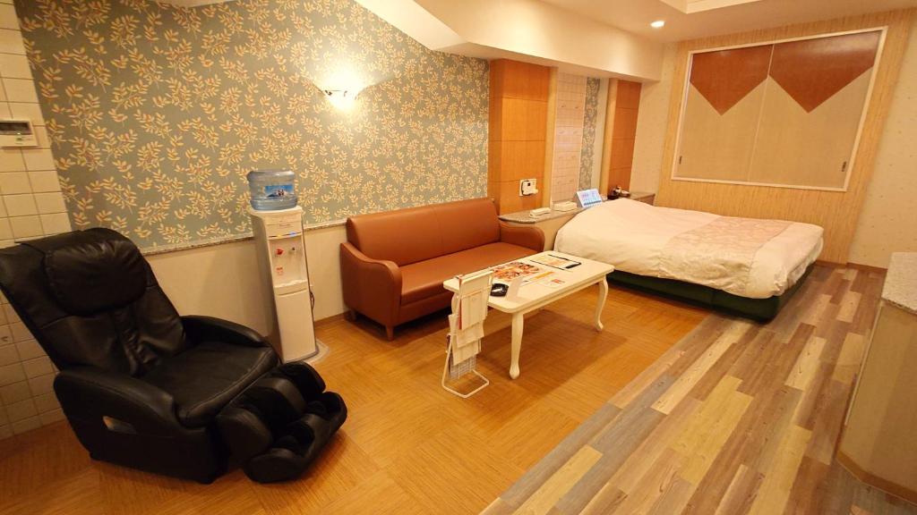 une chambre d'hôpital avec un lit et une chaise dans l'établissement ホテルシエル富士店 富士インター -大人専用-, à Fuji