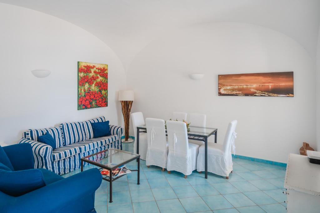 un salon avec un canapé, une table et des chaises dans l'établissement Villa Capri by MyVillaCollection, à Capri