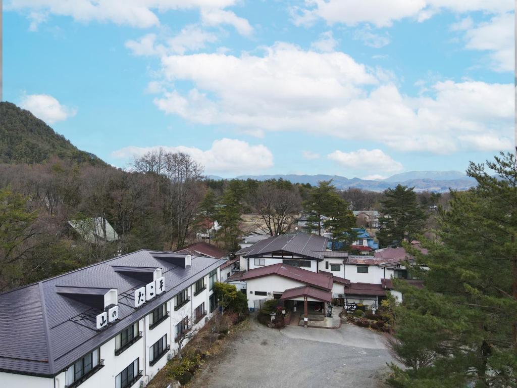 vue aride d'un hôtel avec des montagnes en arrière-plan dans l'établissement 信州安曇野穂高温泉郷　旅館　山のたこ平, à Azumino