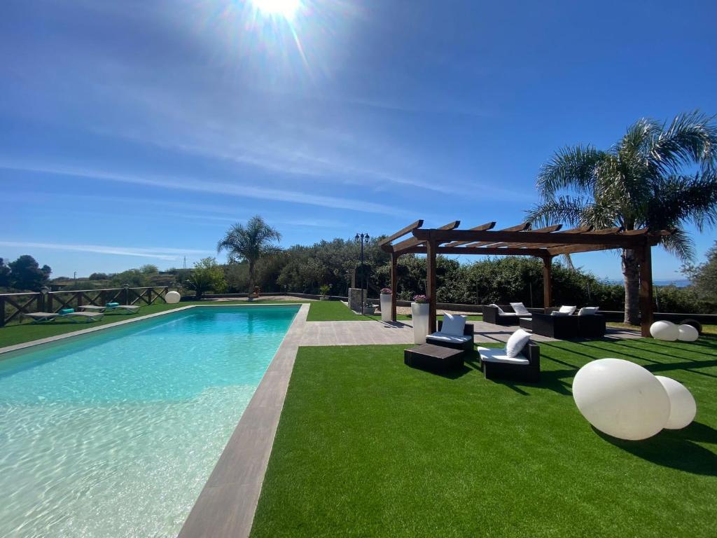 une piscine avec des chaises et un gazebo dans l'établissement Villa Da Campo, à Giardini Naxos