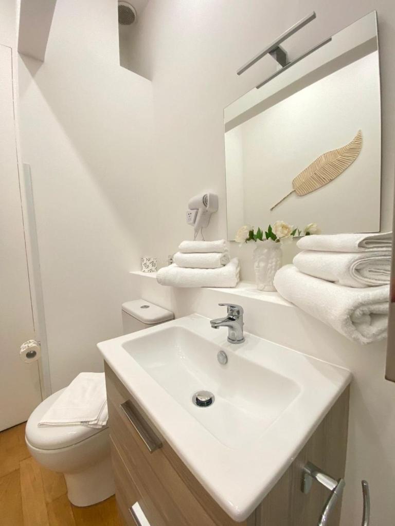 une salle de bain blanche avec un lavabo et des toilettes dans l'établissement Horizon Suites, à Cefalù 62 autres photos