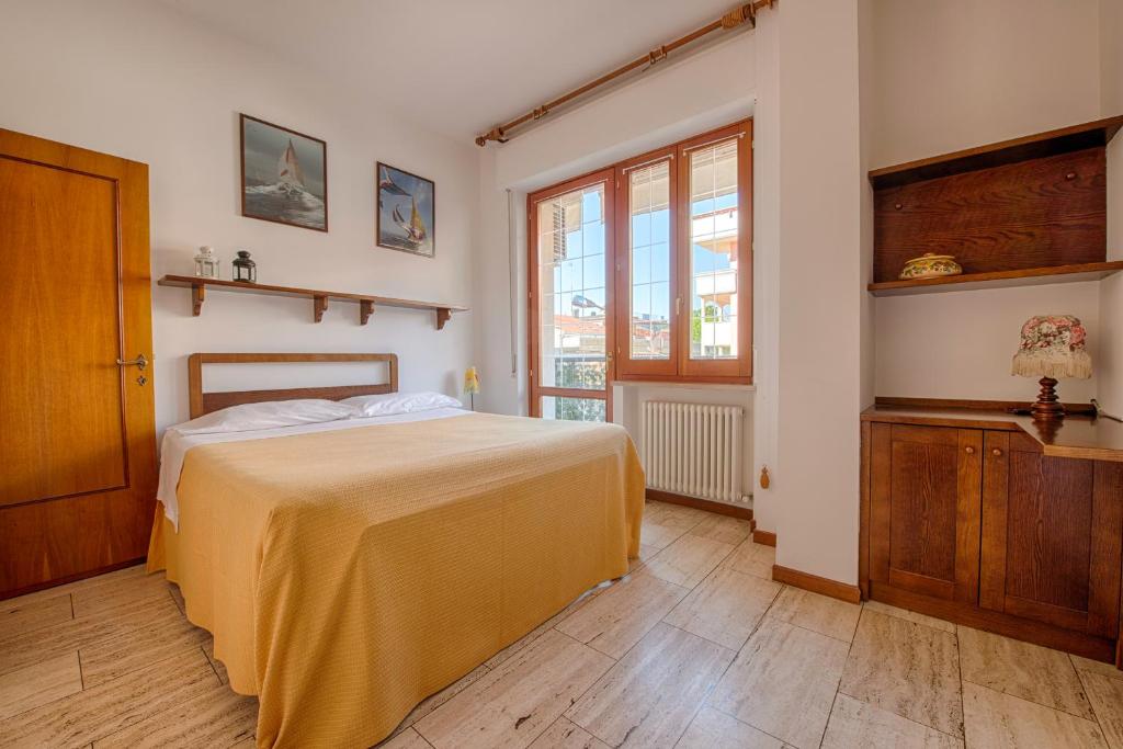 une chambre avec un grand lit et une fenêtre dans l'établissement Residence Palazzo Gasparroni, à Tortoreto Lido