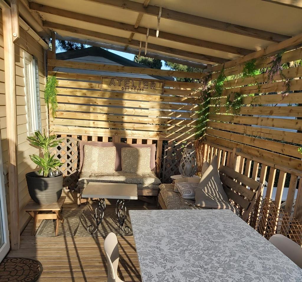 - une terrasse en bois avec un lit et une table dans l'établissement Mob151, à Port-la-Nouvelle 1 autre photo