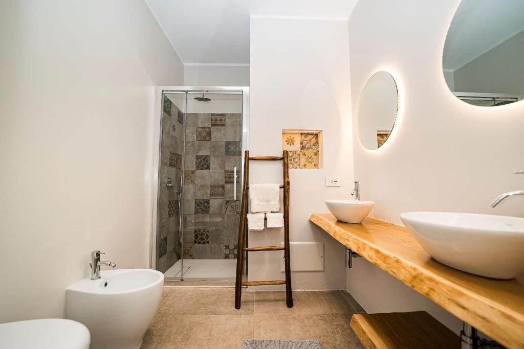 une salle de bain avec deux lavabos et une douche dans l'établissement Villa Caleddha By Vivimy, à Racale