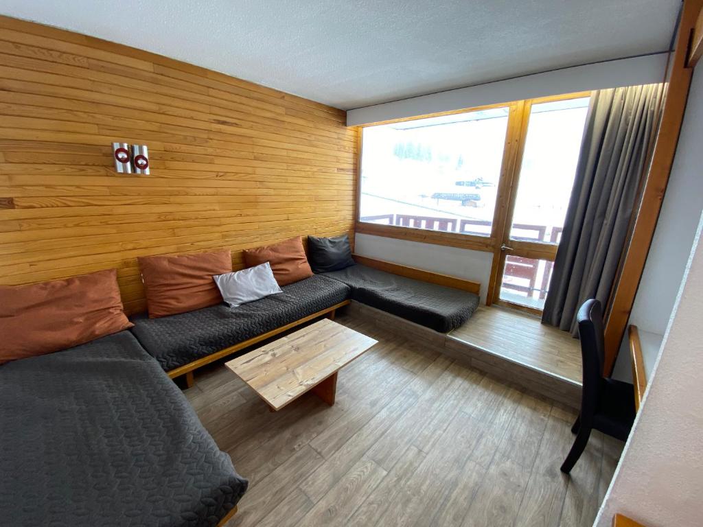 un salon avec un canapé et une table dans l'établissement travelski home classic - Résidence Bellecôte, à La Plagne