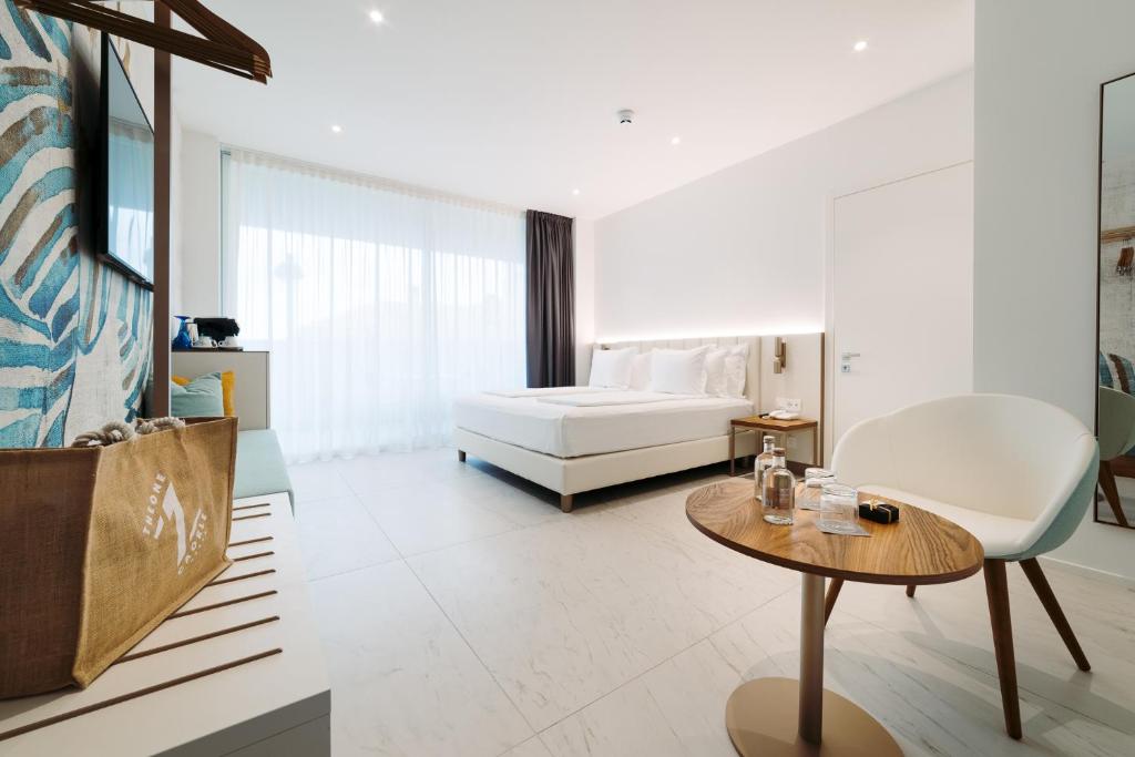 une chambre avec un lit et une table dans une pièce dans l'établissement THE ONE CAORLE - Hotel & Apartments, à Caorle