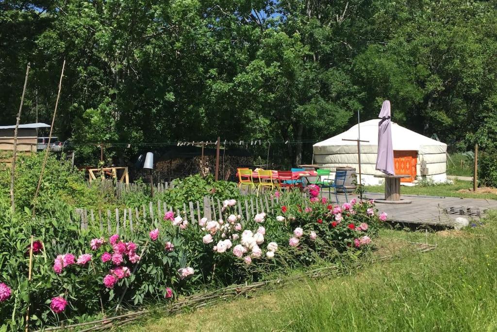 un jardin fleuri devant une yourte dans l'établissement Yourte de la bas, à Curienne