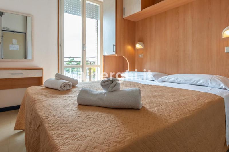 une chambre avec deux lits avec des serviettes sur un lit dans l'établissement Hotel Paradiso, à Rimini 67 autres photos