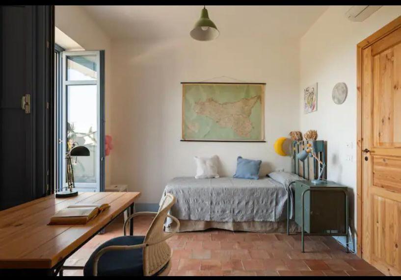 une chambre avec un lit, une table et un bureau dans l'établissement VILLA AZUL, à Castellammare del Golfo