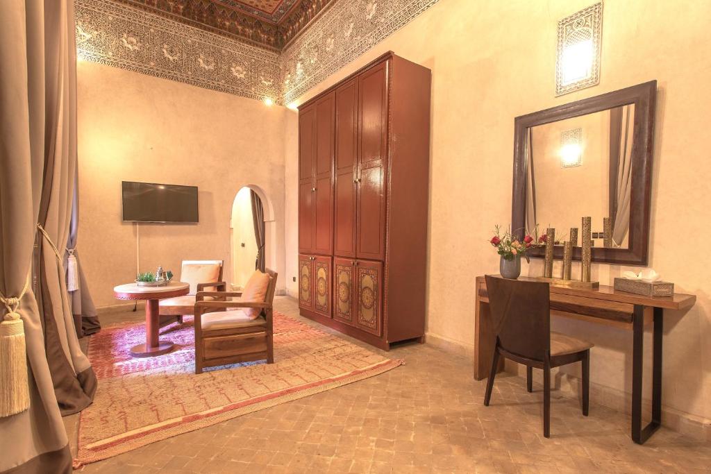 une pièce avec un bureau, une chaise et un miroir dans l'établissement Le Medina Privilège Riad & Spa, à Marrakech