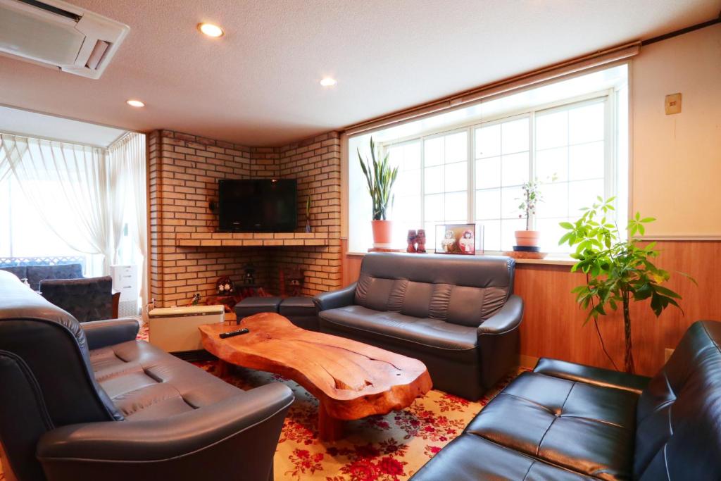 un salon avec un canapé et une table basse dans l'établissement Ryokan Nakaya, à Muraoka