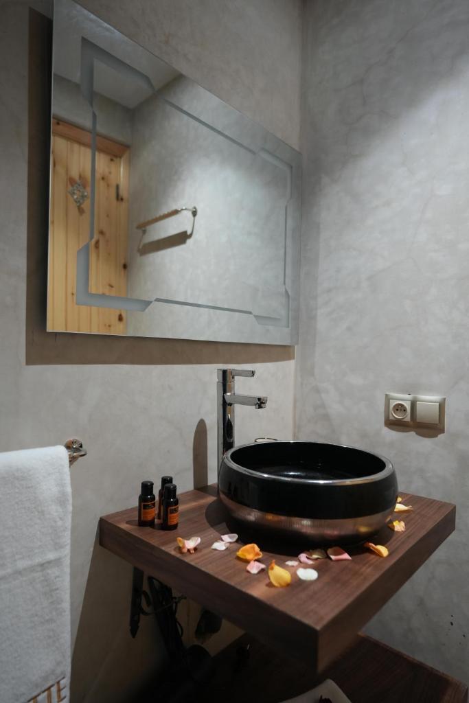 une salle de bain avec des toilettes noires sur une table en bois dans l'établissement Riad Babette, à Essaouira