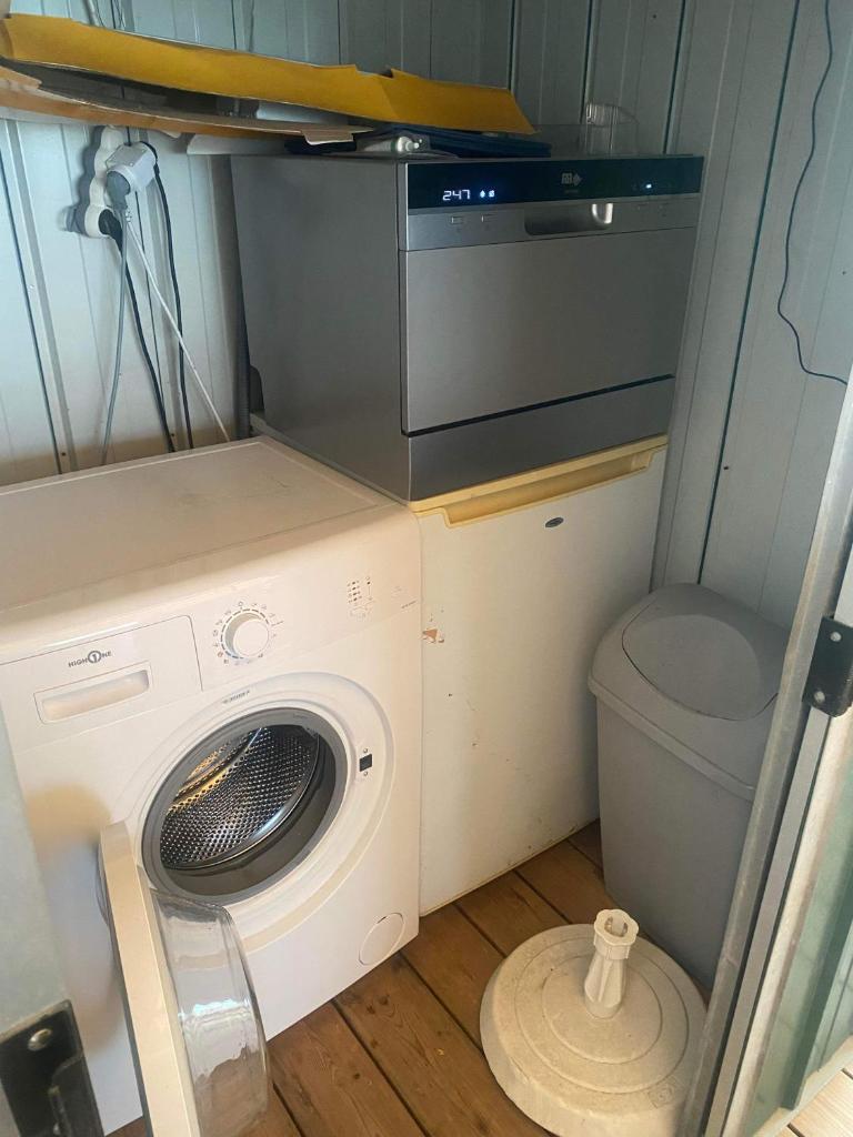 une petite salle de bains avec un lave-linge et des toilettes. dans l'établissement Mobil home de charme à la mer, à Fréjus