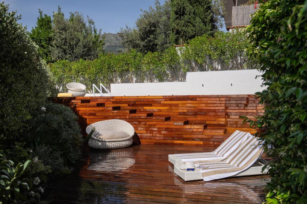 d'une terrasse avec 2 chaises longues et un mur en briques. dans l'établissement Villa Antonella, à Vico Equense