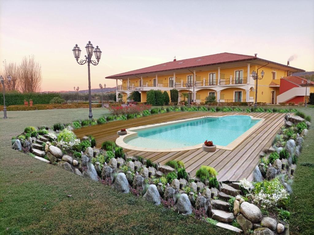 une maison avec une piscine dans une cour dans l'établissement Hotel Lido - Beach and Palace, à Bolsena