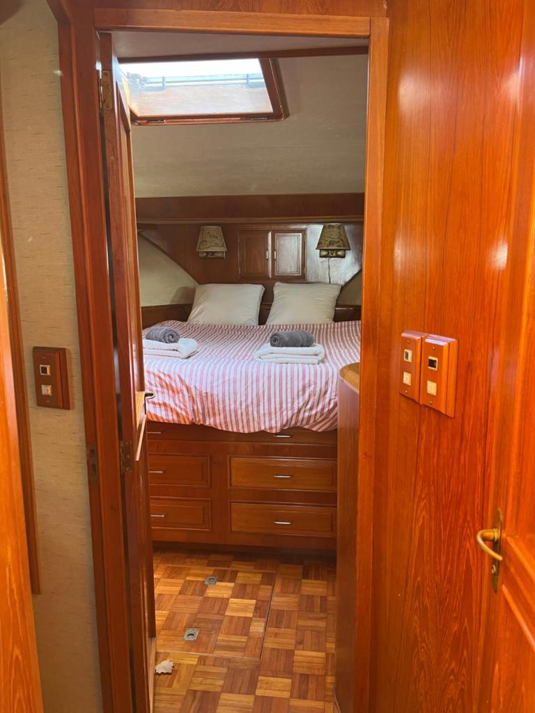 - une petite chambre avec un lit au milieu dans l'établissement Yacht Moineau VI, à Deauville