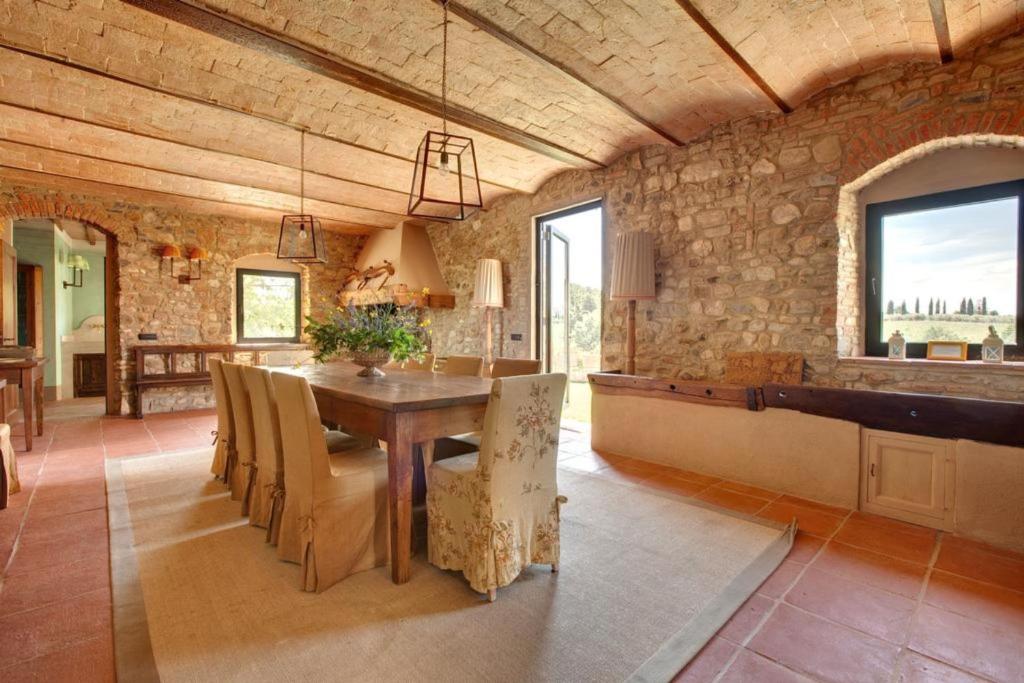 une salle à manger avec une table et un mur en pierre dans l'établissement Villa Il Conventino, à Mercatale Val Di Pesa