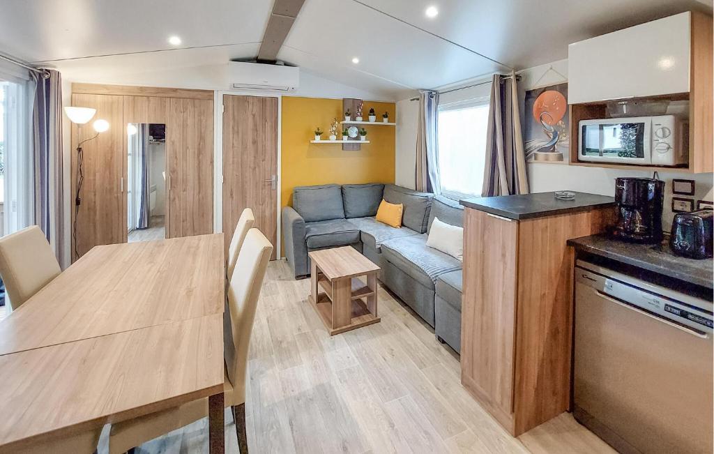une cuisine et un salon avec un canapé et une table dans l'établissement Gorgeous StaCaravan, à Saint-Julien-en-Born