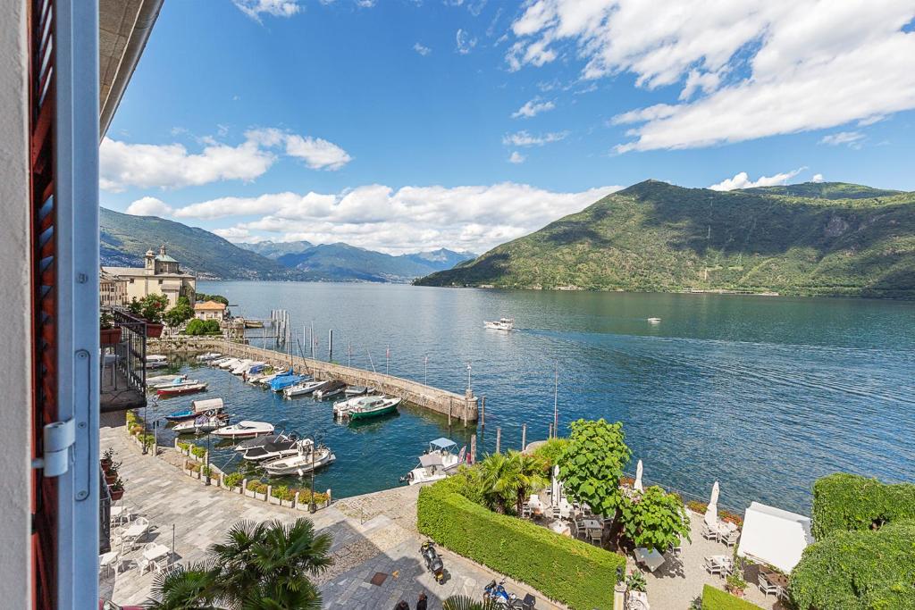 une vue d'une marina avec des bateaux dans l'eau dans l'établissement Hotel Cannobio, à Cannobio