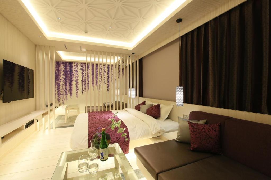 un salon avec un lit et un canapé dans l'établissement HOTEL Miz, à Rifu