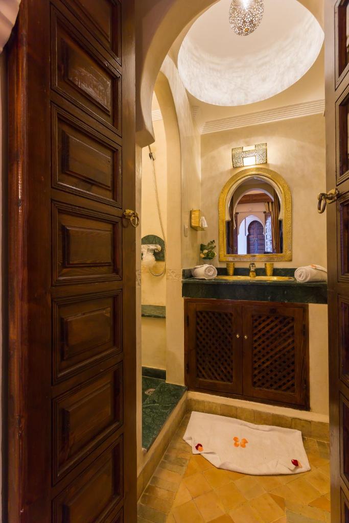 une salle de bain avec un lavabo et un miroir dans l'établissement Riad Amina, à Marrakech
