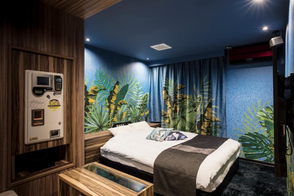 Un ou plusieurs lits dans un hébergement de l'établissement Hotel Chroma - Adult Only