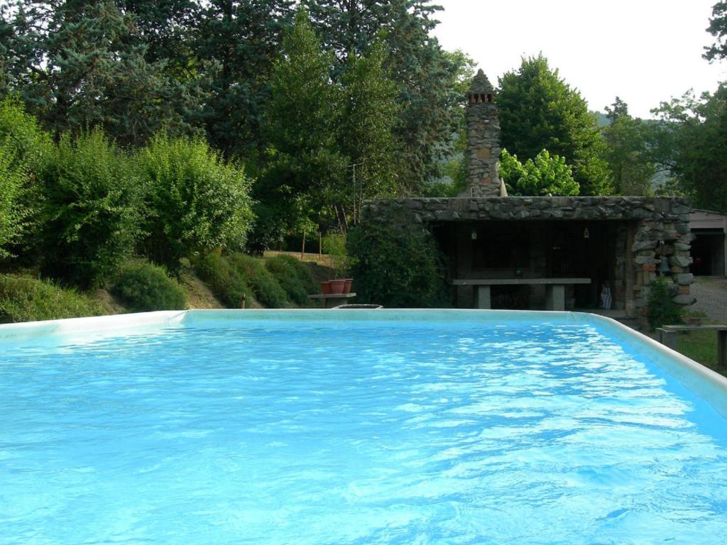 une grande piscine bleue dans une cour dans l'établissement Villa Campo di Fiore, à Arezzo