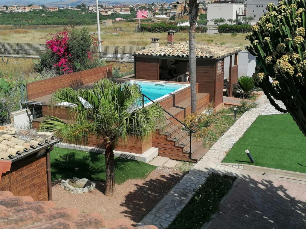 une cour arrière avec une piscine et une maison dans l'établissement Villa Euforbia, à Agrigente