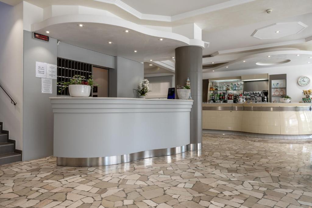 un hall avec un comptoir et un bar dans l'établissement Hotel Bristol, à Caorle 102 autres photos