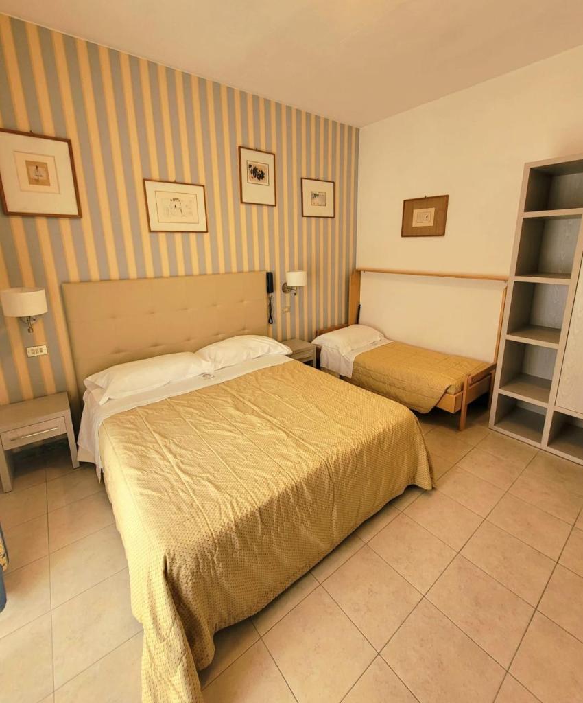 une chambre d'hôtel avec deux lits dans une chambre dans l'établissement Hotel Ariella, à Milano Marittima