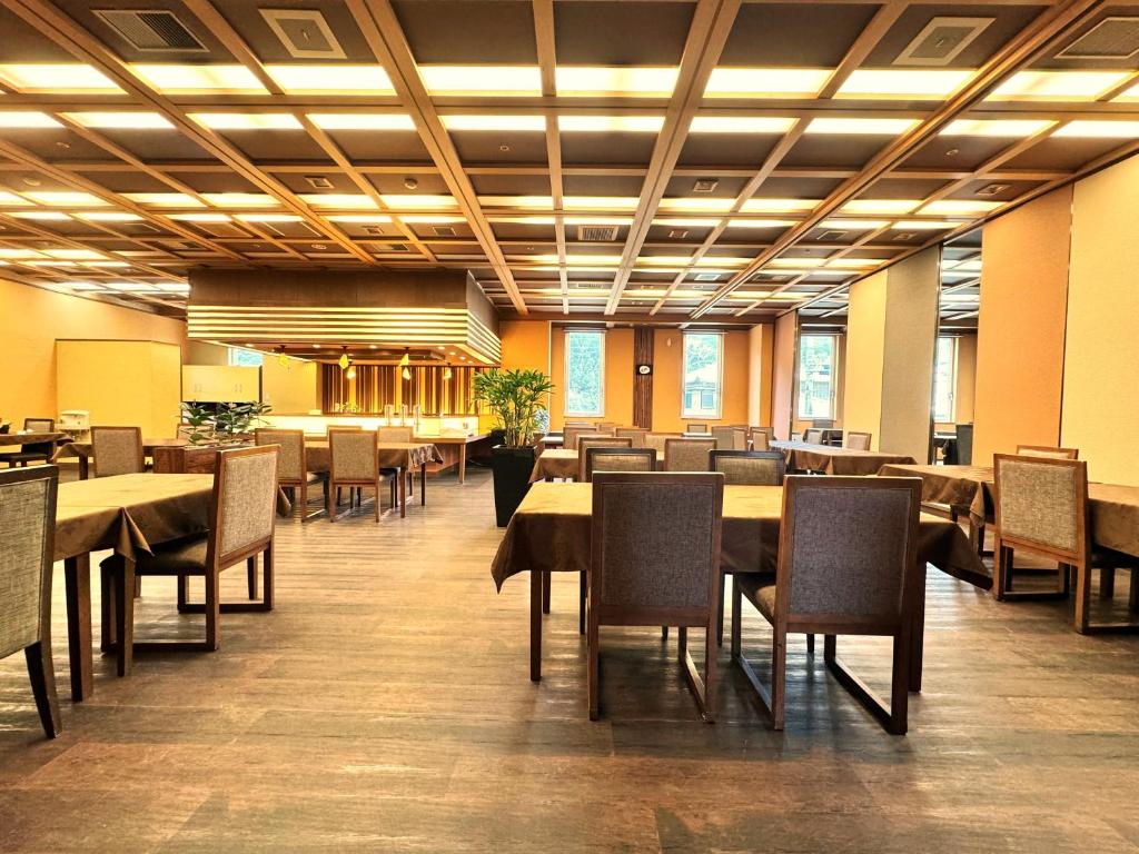 une salle à manger avec tables et chaises dans un bâtiment dans l'établissement Kochoran, à Toba