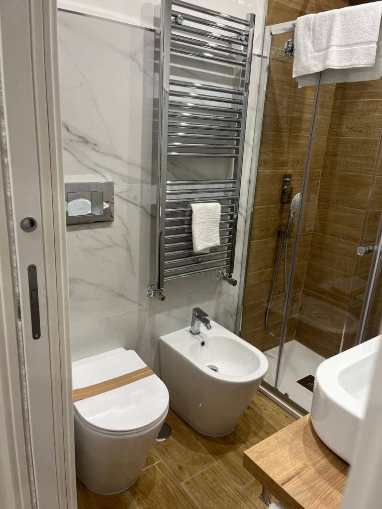une salle de bain avec toilettes, lavabo et douche dans l'établissement Residenza Cristforo Colombo, à Crotone