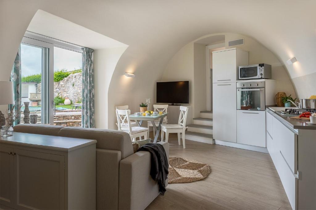 une cuisine et un salon avec un canapé et une table dans l'établissement Villa Le Onde, à Marina dʼAndora