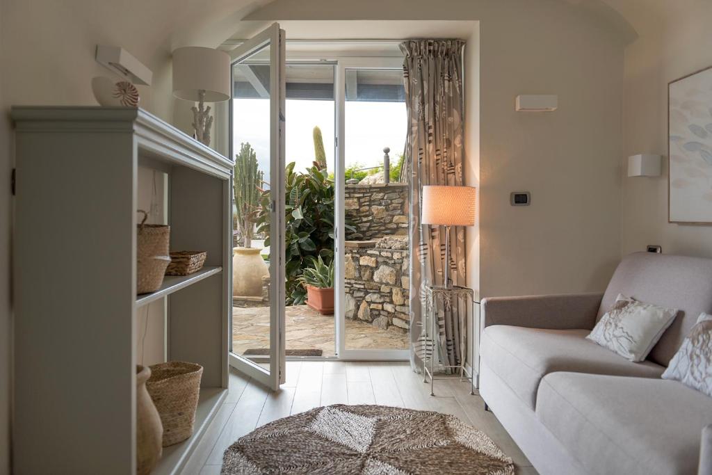 un salon avec un canapé et une porte coulissante en verre dans l'établissement Villa Le Onde, à Marina dʼAndora 29 autres photos