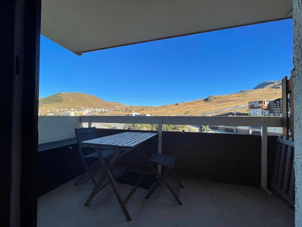 d'un balcon avec une table et une vue sur la montagne. dans l'établissement Homency - Résidence aux Bergers B502, à L'Alpe-d'Huez