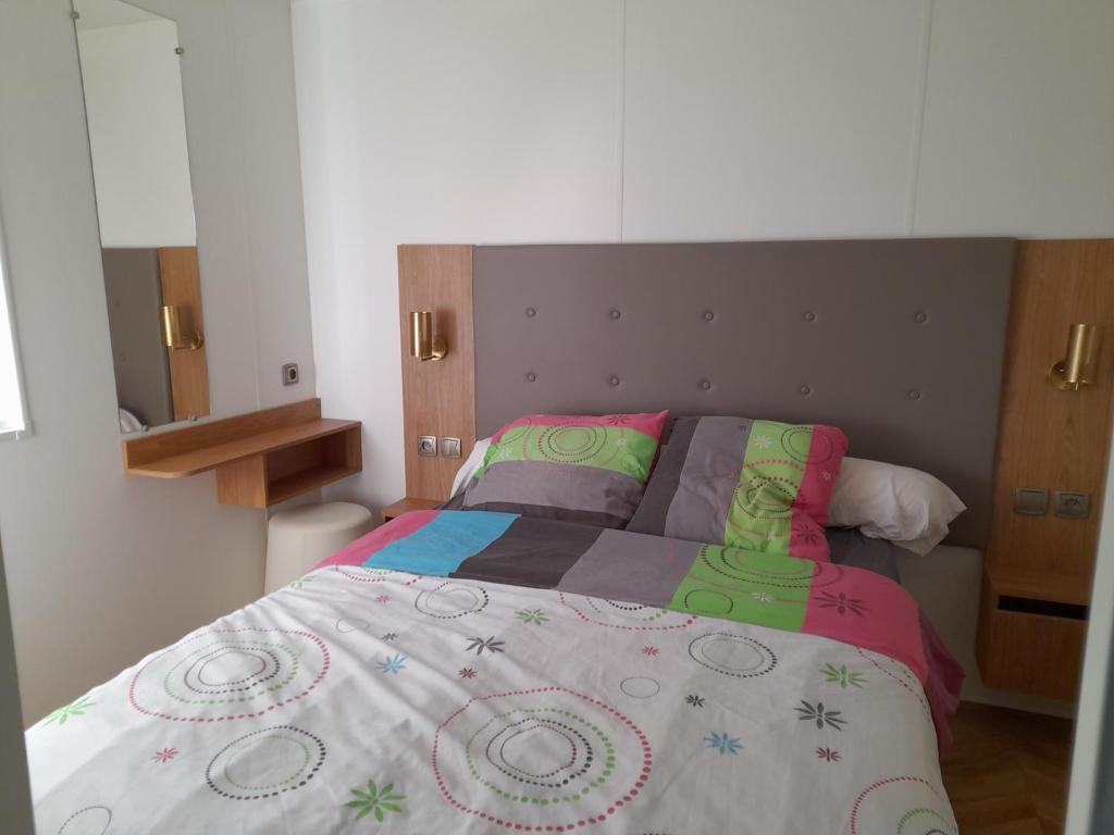 - une chambre avec un lit et une couverture colorée dans l'établissement Camping del Mar 15, Mobile Home Excellence 6 personnes, 3 chambres, 40 m2, à Argelès-sur-Mer