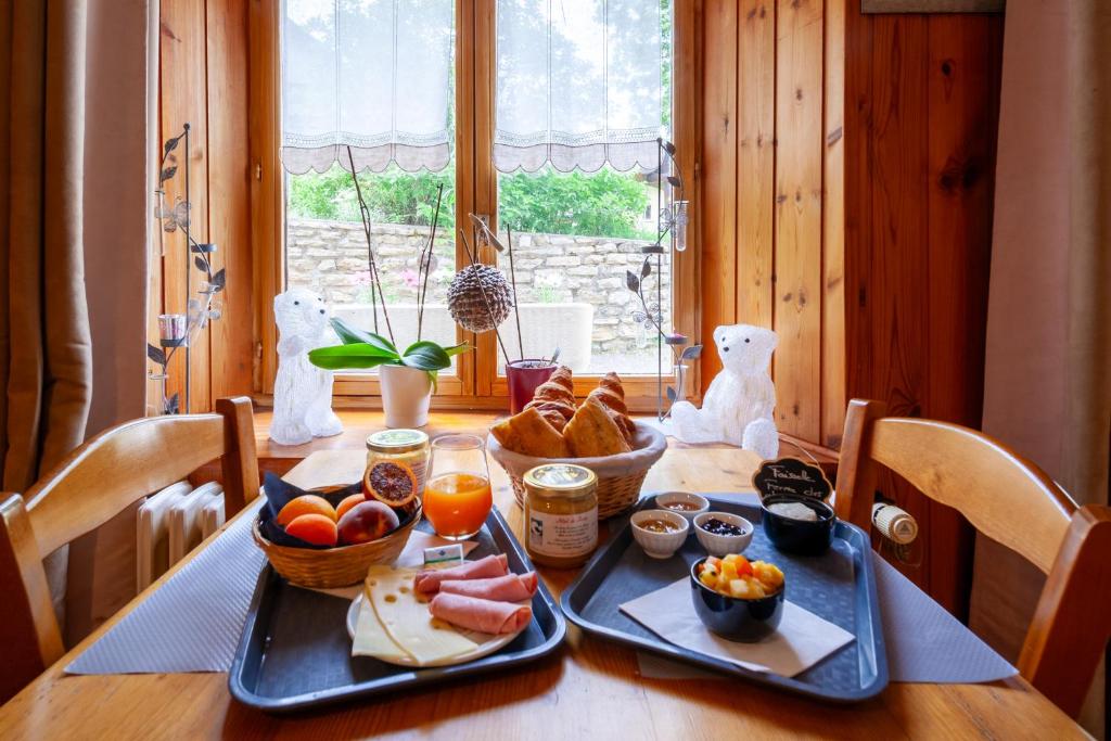 - une table avec deux plateaux de nourriture dans l'établissement Auberge des Montauds - Hôtel & Restaurant, à Villard-de-Lans