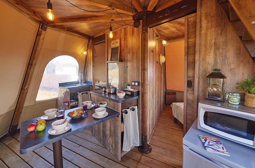 une cuisine avec une table avec de la nourriture dessus dans l'établissement Lodge Tipi, L'Indienne, à Arc-et-Senans