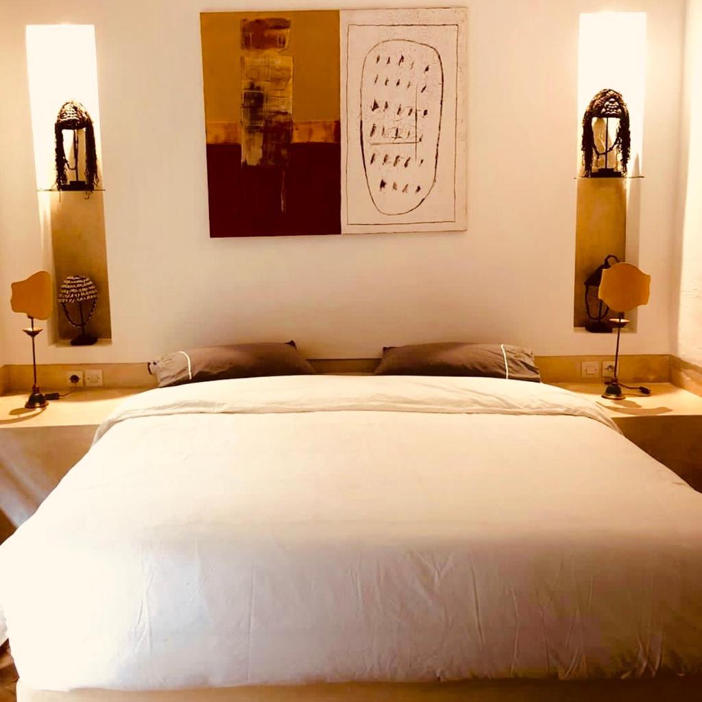 - une chambre avec un lit blanc et 2 lampes dans l'établissement Riad Les 5 Soeurs, à Marrakech