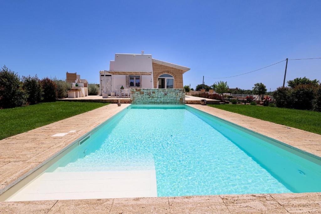 une piscine devant une maison dans l'établissement Villa Brezza dello Ionio, à Marina di Pescoluse