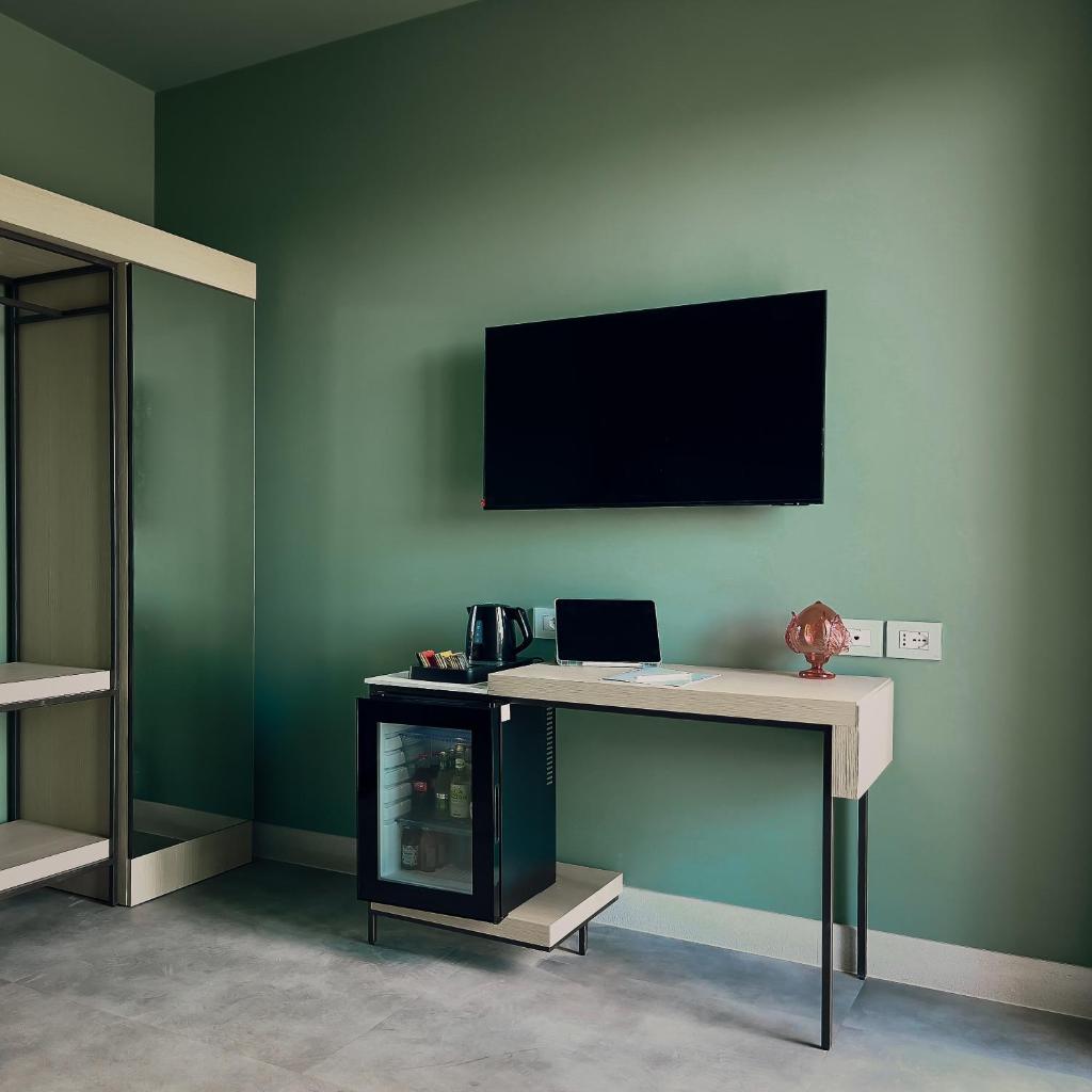 un bureau avec une télévision sur un mur végétal dans l'établissement Maiorano Boutique Hotel, à Manfredonia