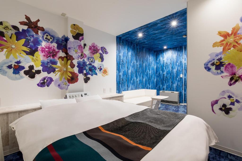 - une chambre avec un lit orné de fleurs sur le mur dans l'établissement HOTEL MONO - Adult only, à Ueda 6 autres photos