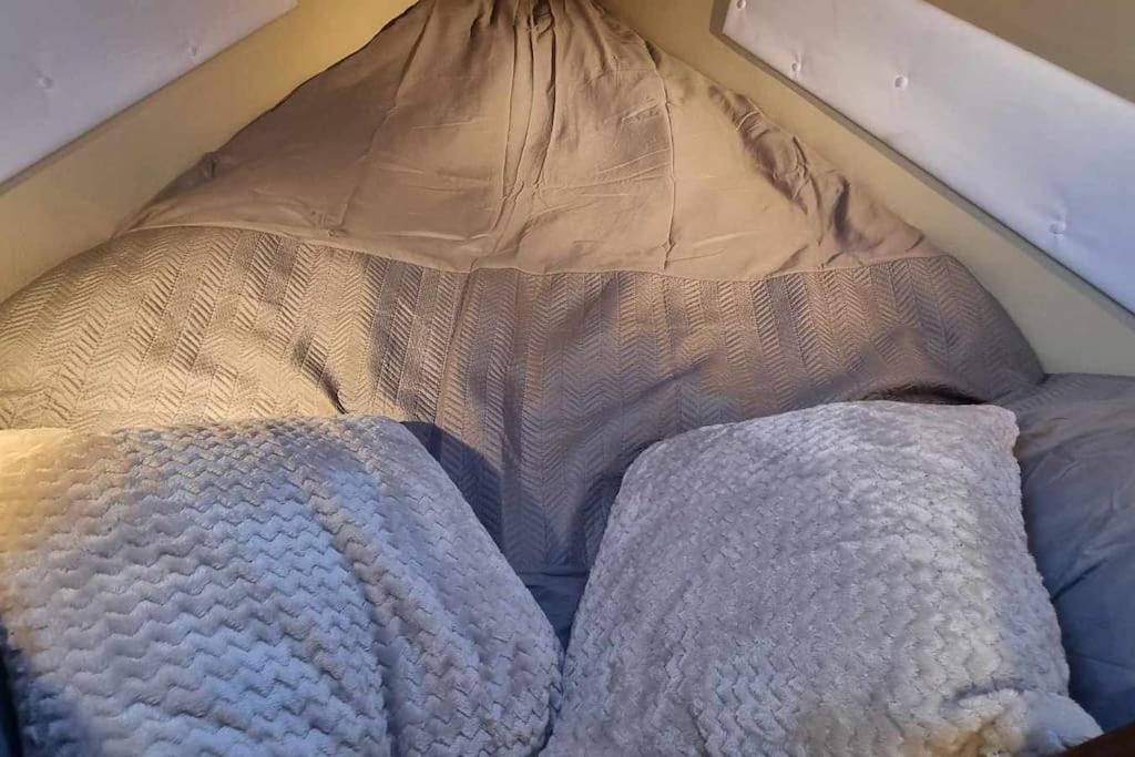 un lit avec deux oreillers dessus dans l'établissement Nuit romantique sur un bateau à Deauville, à Deauville