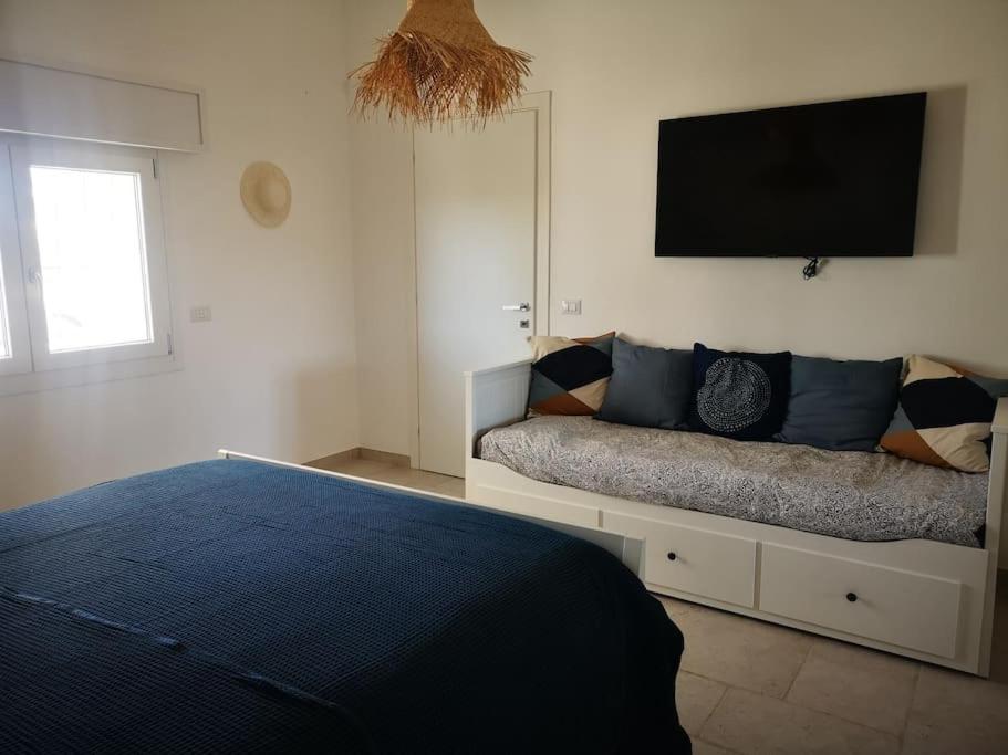 une chambre avec un lit et une télévision à écran plat dans l'établissement Dolce Villa, à Francavilla Fontana